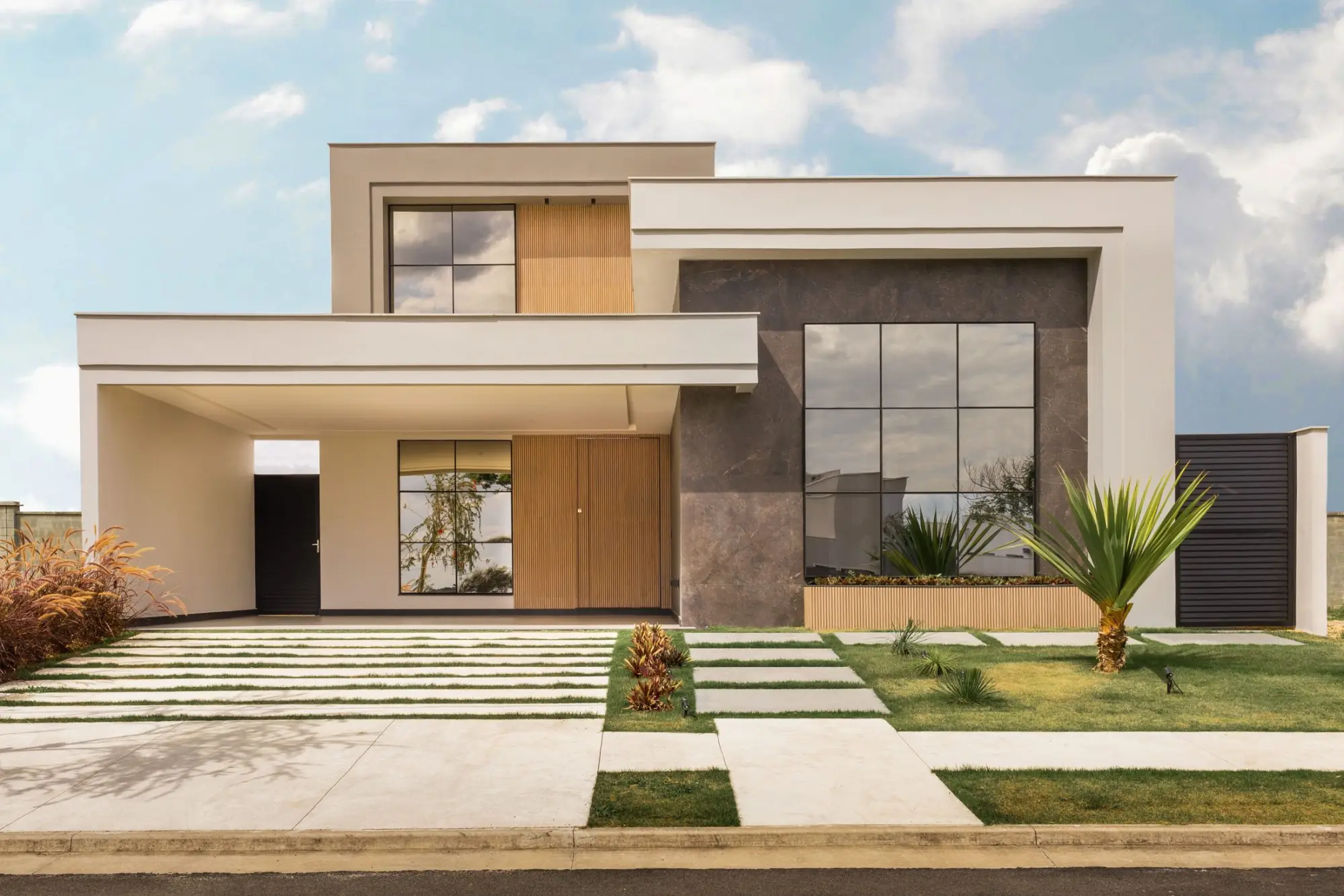 Contemporary two-storey facade in pale render, warm timber and dark stone
