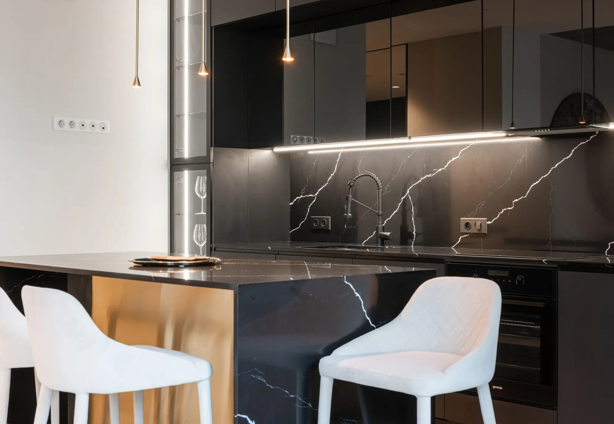 Contemporary kitchen with black marble backsplash and island