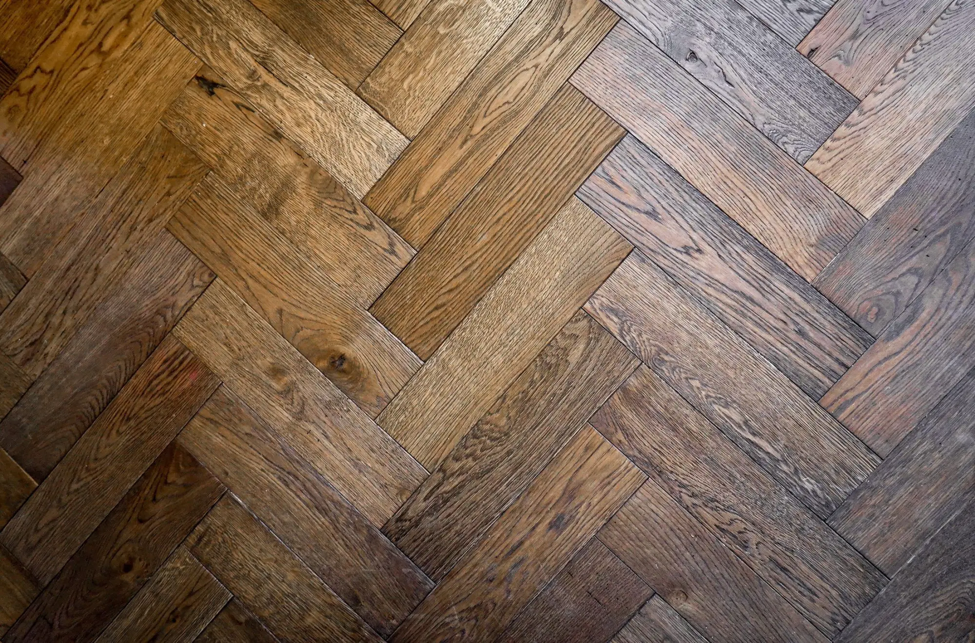 Close view of an oak floor laid in a herringbone pattern